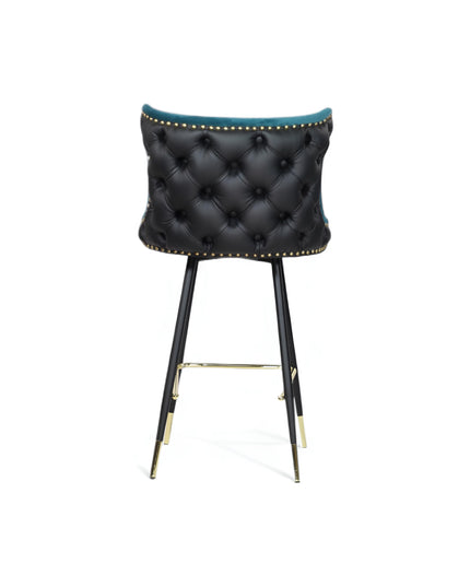 Modern bar stool with a sculpted teal velvet seat and high backrest, featuring black tufted faux leather on the outer back, brass nailhead trim, and slim black metal legs with gold accents and a footrest-ideal for kitchen islands or stylish bar areas