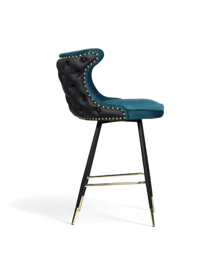 Modern bar stool with a sculpted teal velvet seat and high backrest, featuring black tufted faux leather on the outer back, brass nailhead trim, and slim black metal legs with gold accents and a footrest-ideal for kitchen islands or stylish bar areas