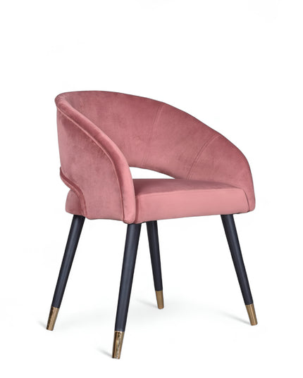 Curved-back pink modern chair with wraparound design, cushioned seat, and brass-tipped black legs
