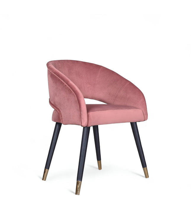 Curved-back pink modern chair with wraparound design, cushioned seat, and brass-tipped black legs