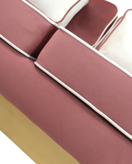 Pink velvet sofa with gold base on a white background