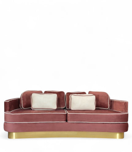 Pink velvet sofa with gold base on a white background