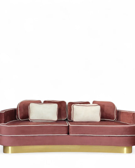 Pink velvet sofa with gold base on a white background