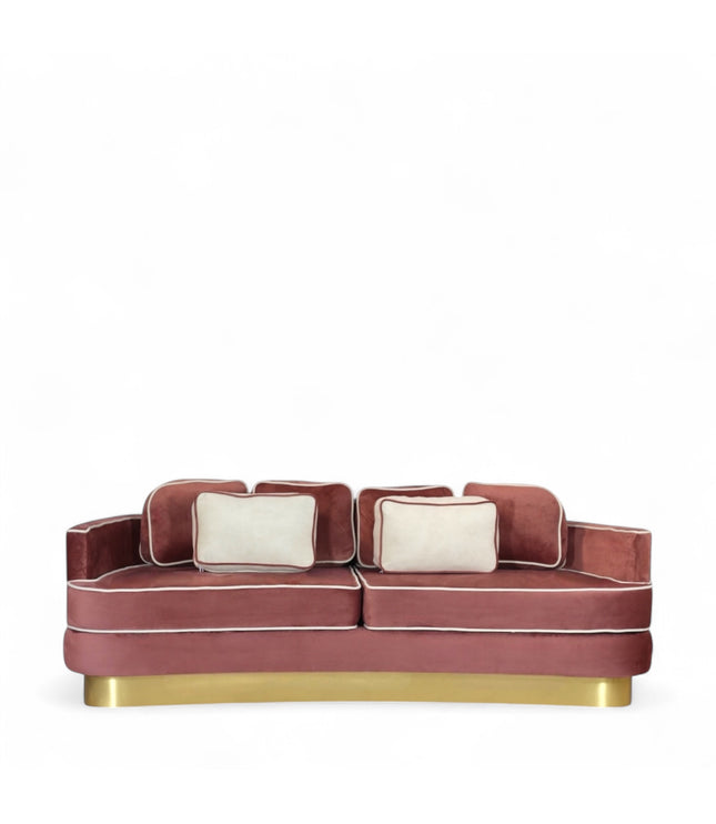 Pink velvet sofa with gold base on a white background
