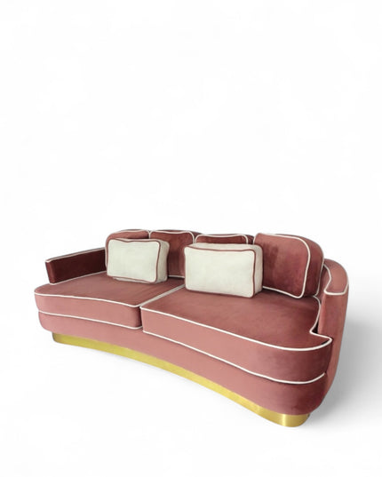 Pink velvet sofa with gold base on a white background