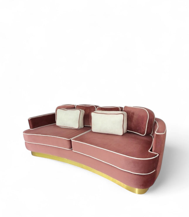 Pink velvet sofa with gold base on a white background