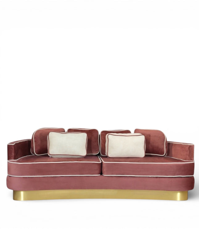 Pink velvet sofa with gold legs on a white background