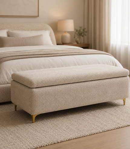 Beige upholstered bench in front of a bed in a bedroom setting