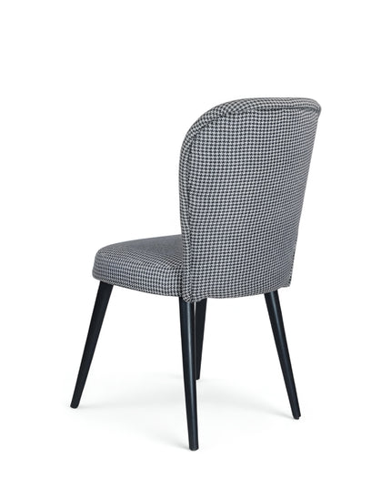 Contemporary dining chair with black and white houndstooth upholstery and tapered black legs — perfect for modern, minimalist, or Scandinavian interiors.