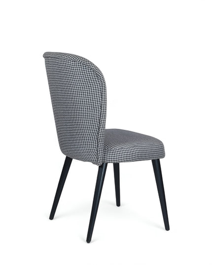 Contemporary dining chair with black and white houndstooth upholstery and tapered black legs — perfect for modern, minimalist, or Scandinavian interiors.