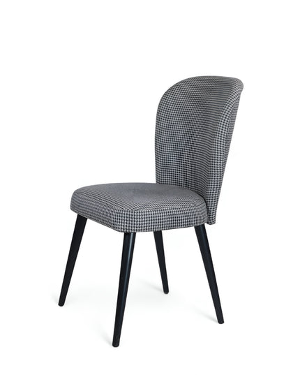 Contemporary dining chair with black and white houndstooth upholstery and tapered black legs — perfect for modern, minimalist, or Scandinavian interiors.