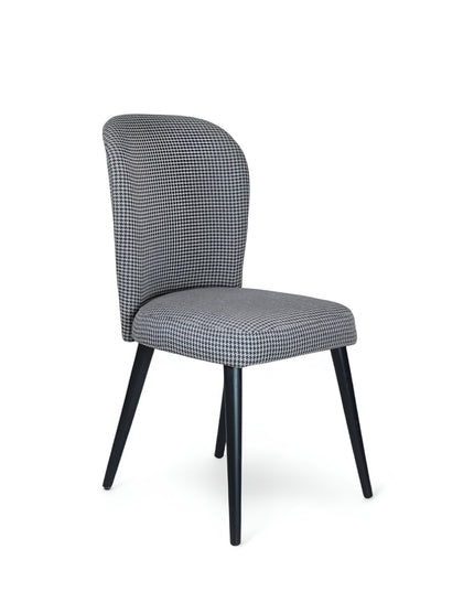 Contemporary dining chair with black and white houndstooth upholstery and tapered black legs — perfect for modern, minimalist, or Scandinavian interiors.