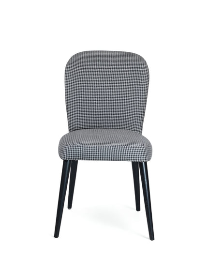 Contemporary dining chair with black and white houndstooth upholstery and tapered black legs — perfect for modern, minimalist, or Scandinavian interiors.