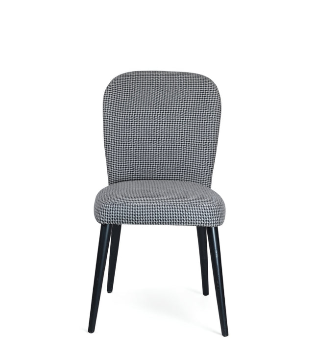 Contemporary dining chair with black and white houndstooth upholstery and tapered black legs — perfect for modern, minimalist, or Scandinavian interiors.