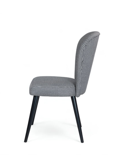 Contemporary dining chair with black and white houndstooth upholstery and tapered black legs — perfect for modern, minimalist, or Scandinavian interiors.
