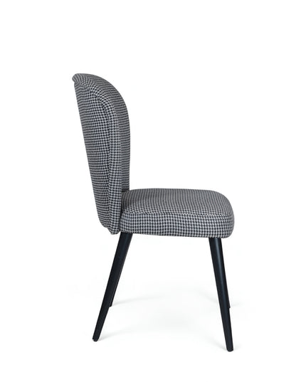 Contemporary dining chair with black and white houndstooth upholstery and tapered black legs — perfect for modern, minimalist, or Scandinavian interiors.