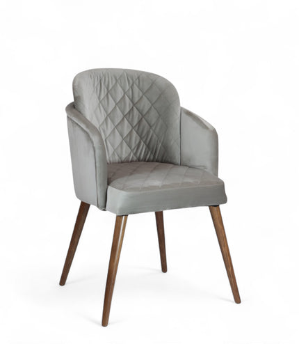 Modern dining chair with light grey diamond-stitched velvet upholstery and angled walnut wooden legs — ideal for contemporary interiors and luxury dining spaces.