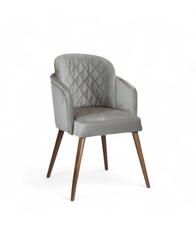 Modern dining chair with light grey diamond-stitched velvet upholstery and angled walnut wooden legs — ideal for contemporary interiors and luxury dining spaces.