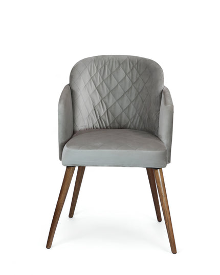 Modern dining chair with light grey diamond-stitched velvet upholstery and angled walnut wooden legs — ideal for contemporary interiors and luxury dining spaces.