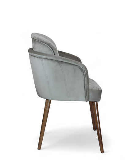 Modern dining chair with light grey diamond-stitched velvet upholstery and angled walnut wooden legs — ideal for contemporary interiors and luxury dining spaces.