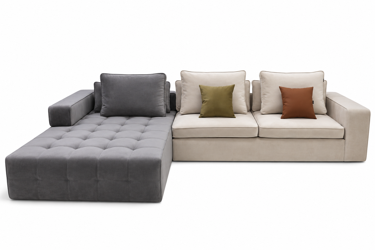 A modern sectional sofa with a tufted gray chaise lounge on the left, connected to a light beige three-seat section with cream cushions and two accent pillows in olive green and rust brown, shown on a white background.