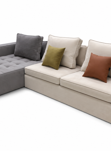 A modern L-shaped sectional sofa with a tufted chaise lounge on the left, upholstered in light beige fabric with a dark gray accent section. The sofa is styled with multiple throw pillows, including two beige pillows, one olive green pillow, and one rust brown pillow, set against a plain white background.