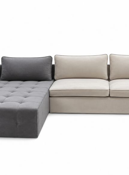 A modern sectional sofa with a left-facing chaise lounge, featuring a tufted dark gray chaise and matching back cushion, and light beige seat and back cushions on a plain white background.
