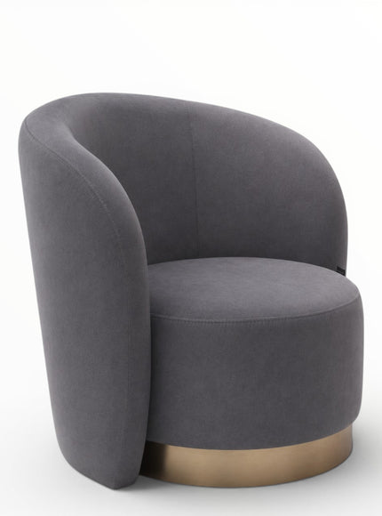 A modern barrel-style accent chair upholstered in dark gray fabric with a brushed gold metal base, shown on a clean white background.