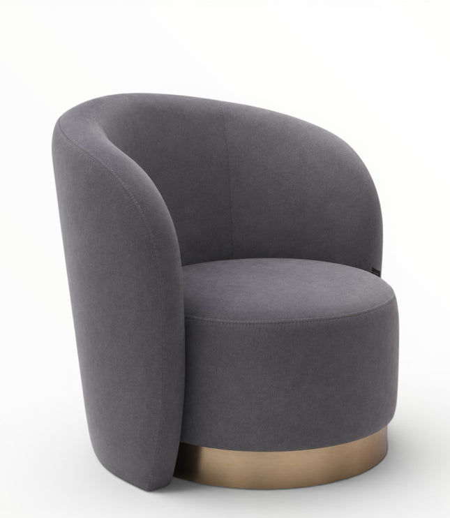 A modern barrel-style accent chair upholstered in dark gray fabric with a brushed gold metal base, shown on a clean white background.