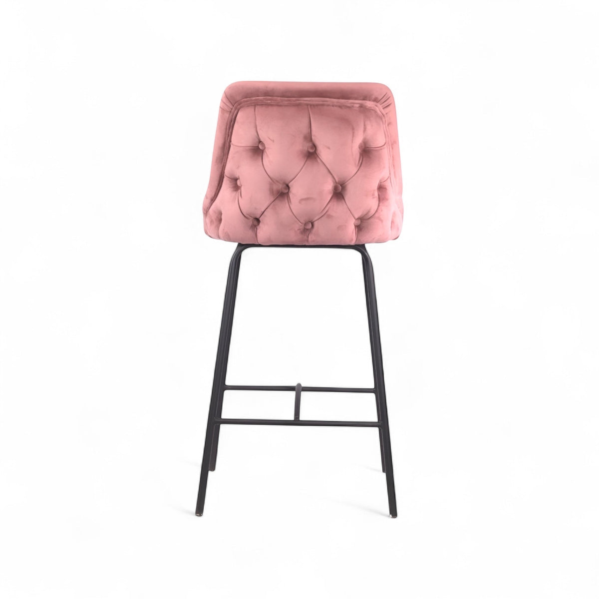 Modern bar stool with a high backrest and seat upholstered in blush pink velvet, featuring button-tufted detailing and slim black metal legs with a built-in footrest, ideal for kitchen islands or contemporary bar spaces