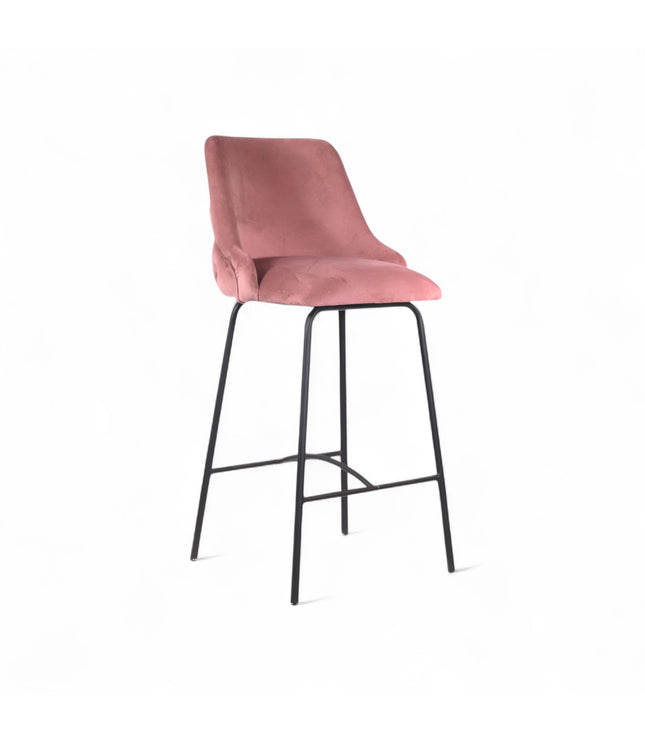 Modern bar stool with a high backrest and seat upholstered in blush pink velvet, featuring button-tufted detailing and slim black metal legs with a built-in footrest, ideal for kitchen islands or contemporary bar spaces