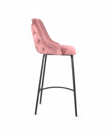 Modern bar stool with a high backrest and seat upholstered in blush pink velvet, featuring button-tufted detailing and slim black metal legs with a built-in footrest, ideal for kitchen islands or contemporary bar spaces