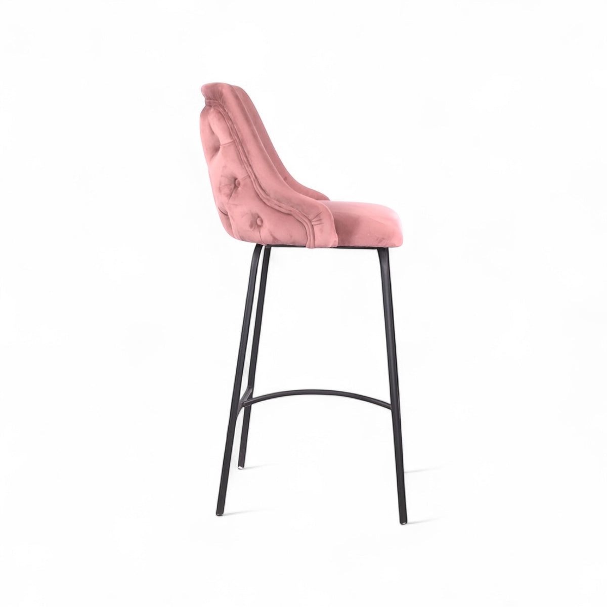 Modern bar stool with a high backrest and seat upholstered in blush pink velvet, featuring button-tufted detailing and slim black metal legs with a built-in footrest, ideal for kitchen islands or contemporary bar spaces