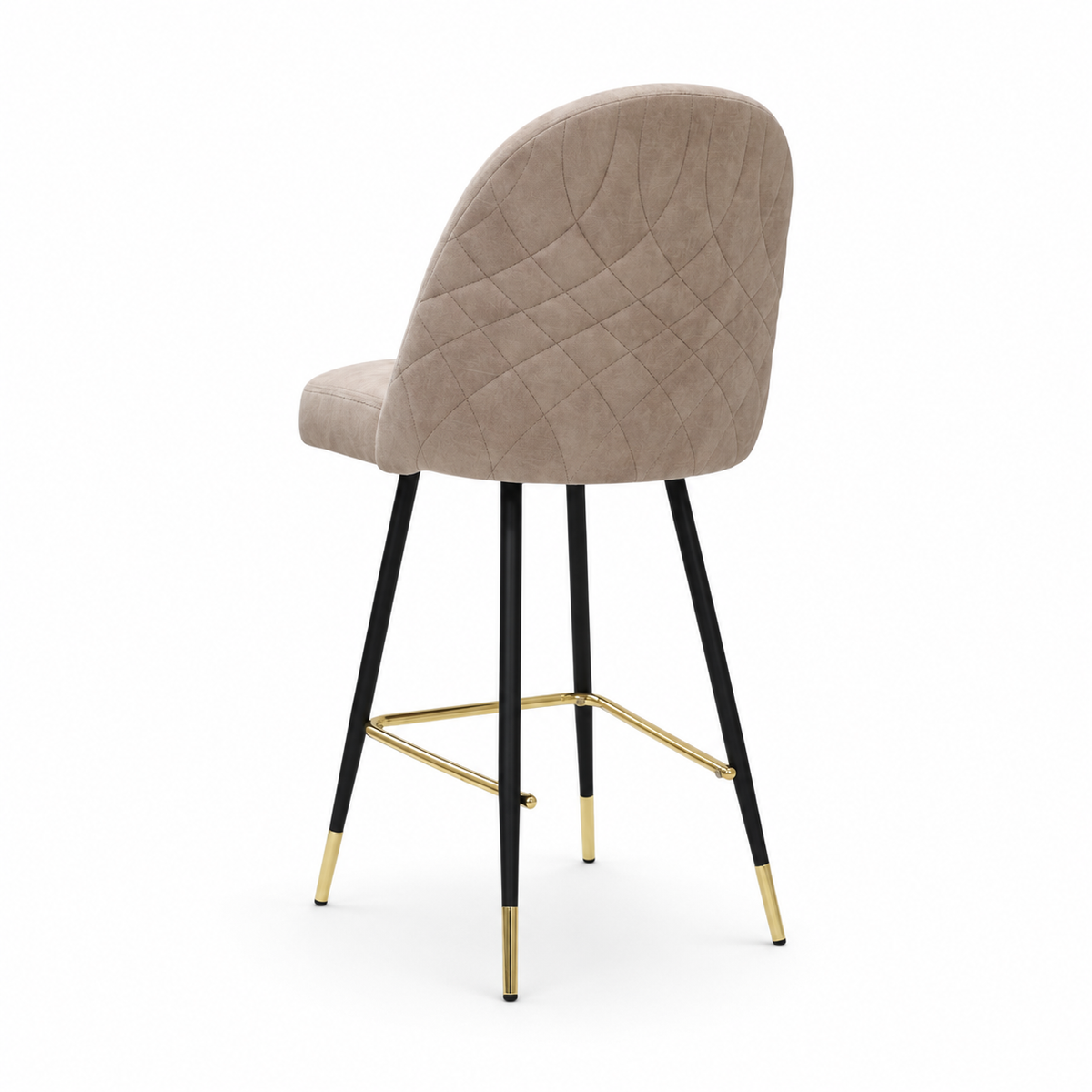 A modern bar stool with a rounded, upholstered seat and backrest in a taupe-beige fabric, supported by slim black metal legs accented with gold hardware and gold-colored foot caps, set against a plain white background.