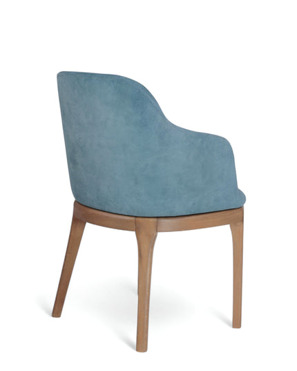 Contemporary dining chair with soft blue upholstery and natural wood legs — perfect for modern dining rooms, boutique cafés, or elegant home offices.