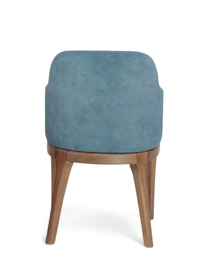 Contemporary dining chair with soft blue upholstery and natural wood legs — perfect for modern dining rooms, boutique cafés, or elegant home offices.