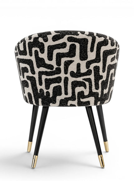Chair with black and white patterned seat on a white background