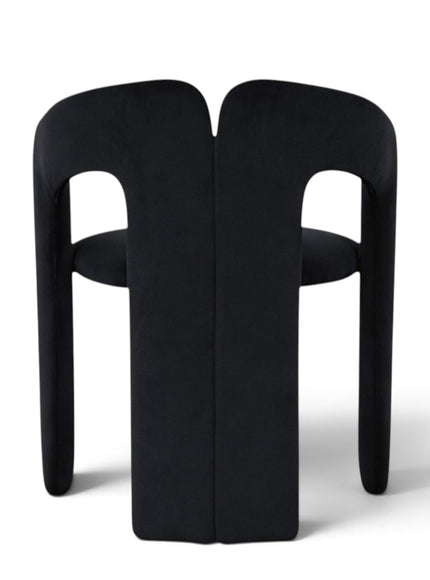 A modern black upholstered dining chair with a unique sculptural backrest and integrated seat, shown from the rear on a white background.