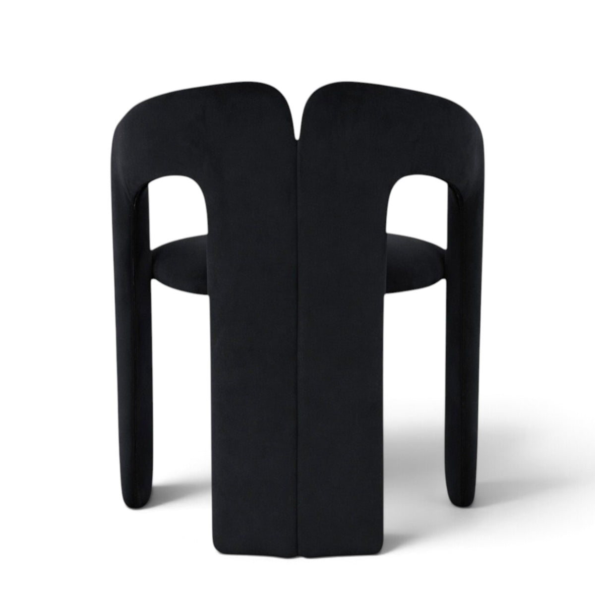 A modern black upholstered dining chair with a unique sculptural backrest and integrated seat, shown from the rear on a white background.