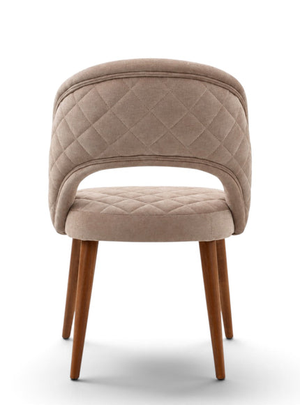 Argent beige upholstered dining chair with crescent-shaped backrest, quilted seat and tapered wooden legs.
