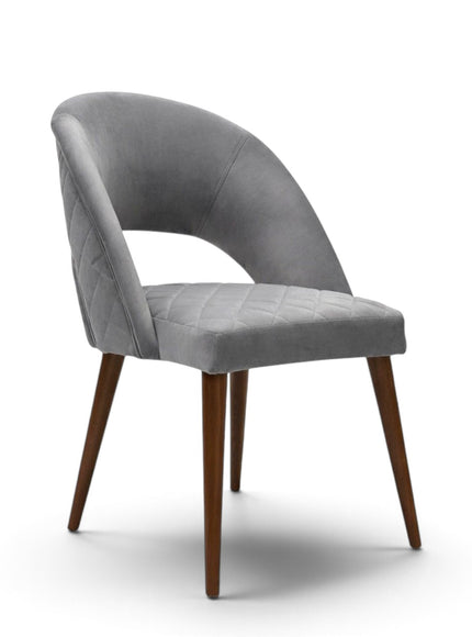 Argent grey upholstered dining chair with curved open backrest, diamond-quilted seat and brown wooden legs.