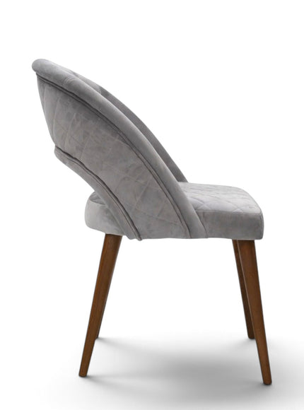 Argent grey upholstered dining chair with curved open backrest, diamond-quilted seat and brown wooden legs.