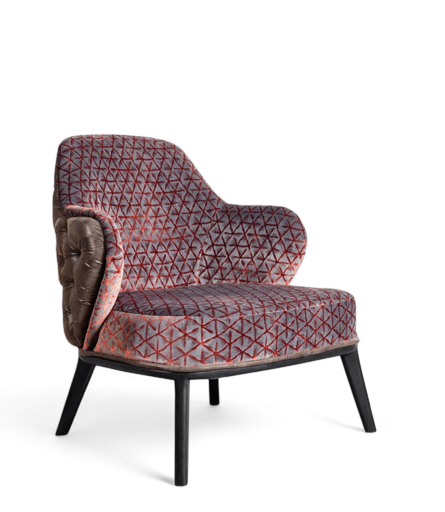 Array armchair with geometric fabric upholstery, deep button-tufted leather-look back, and black tapered wooden legs.