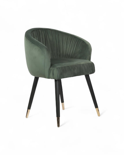 Modern forest green velvet barrel accent chair with pleated backrest and black metal legs with gold tips, perfect for living room or vanity seating.
