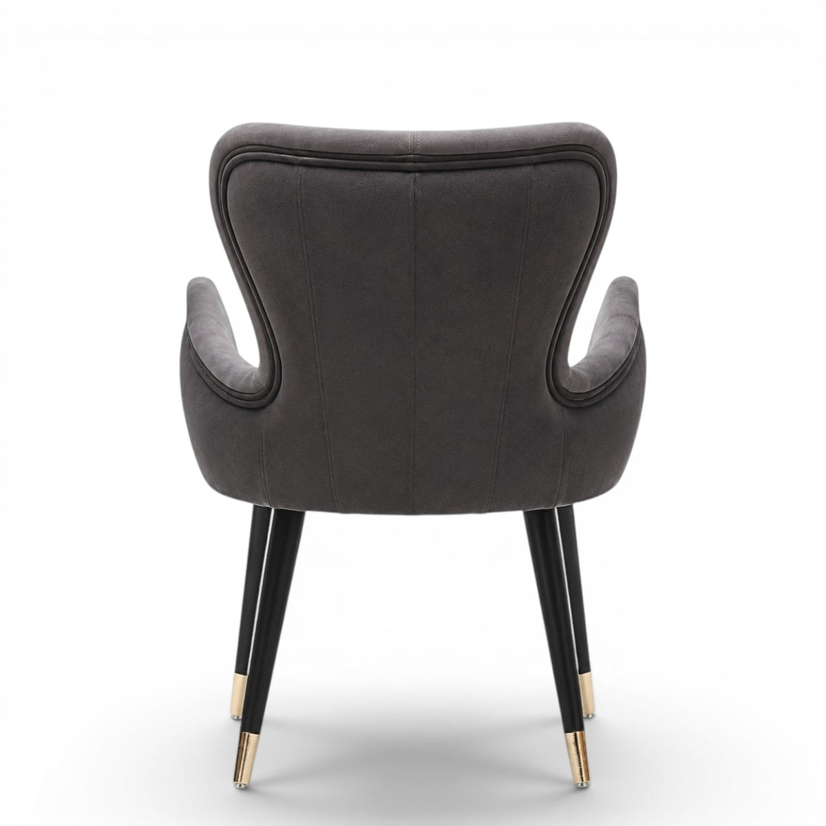 A modern gray velvet dining chair with black tapered legs and gold-toned metal tips, shown against a plain white background.