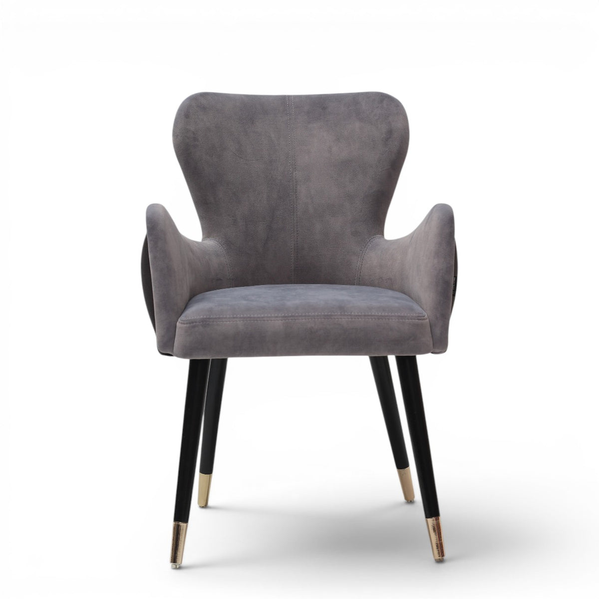A modern gray velvet dining chair with black tapered legs and gold-toned metal tips, shown against a plain white background.