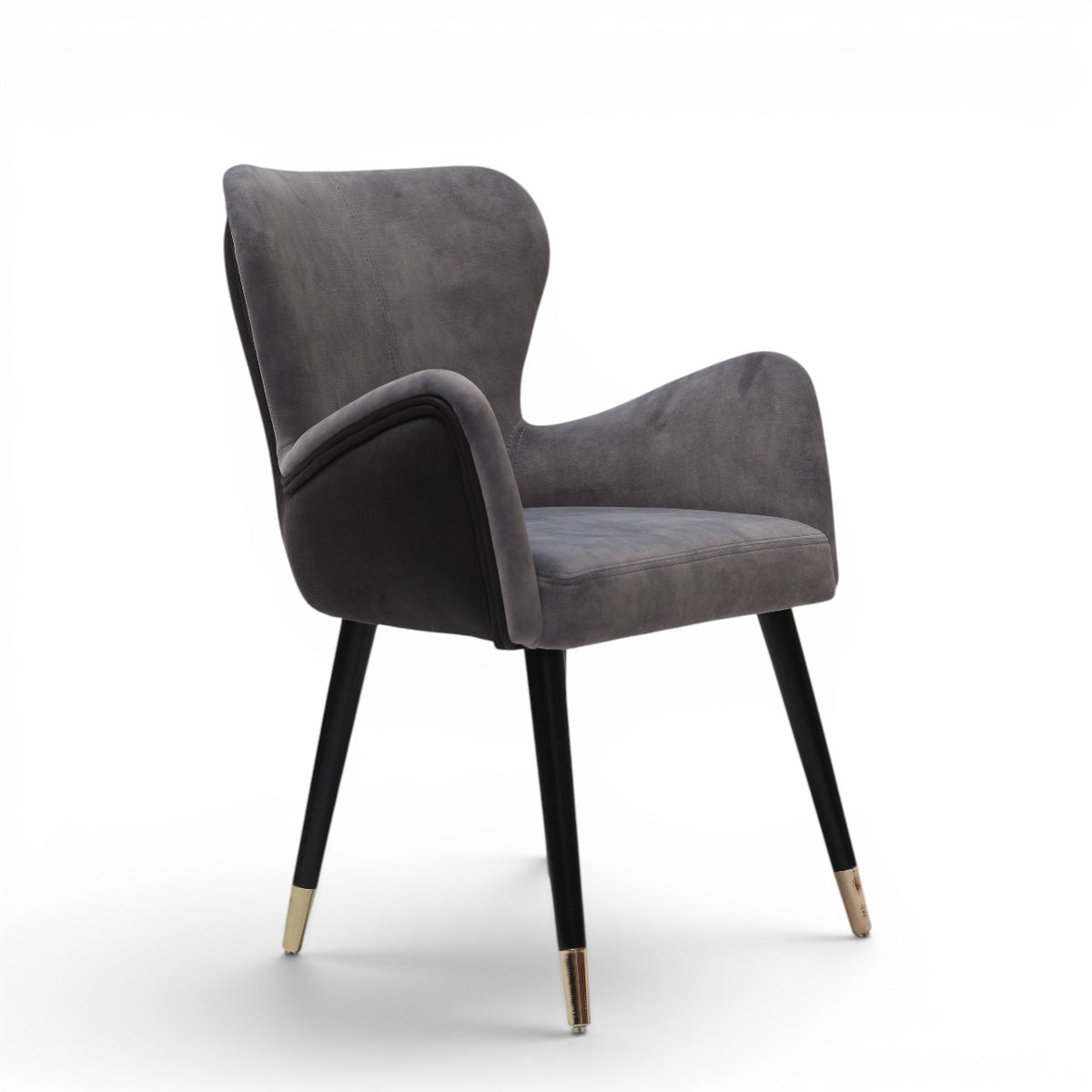 A modern gray velvet dining chair with black tapered legs and gold-toned metal tips, shown against a plain white background.