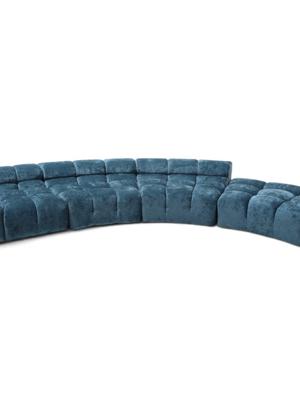 A curved modular sectional sofa upholstered in a plush, tufted velvet fabric in a muted teal blue color, shown against a plain white background.