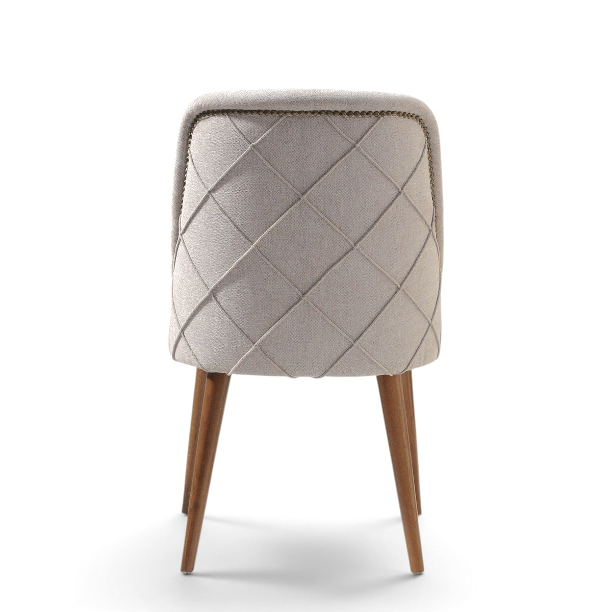 A modern upholstered dining chair with a diamond-quilted backrest in light beige fabric, supported by four tapered medium-brown wooden legs, shown against a plain white background.