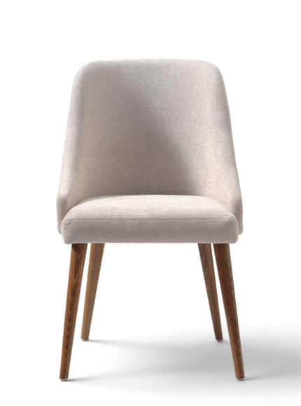 A modern dining chair with a light beige textured fabric upholstery and tapered wooden legs, shown against a plain white background.
